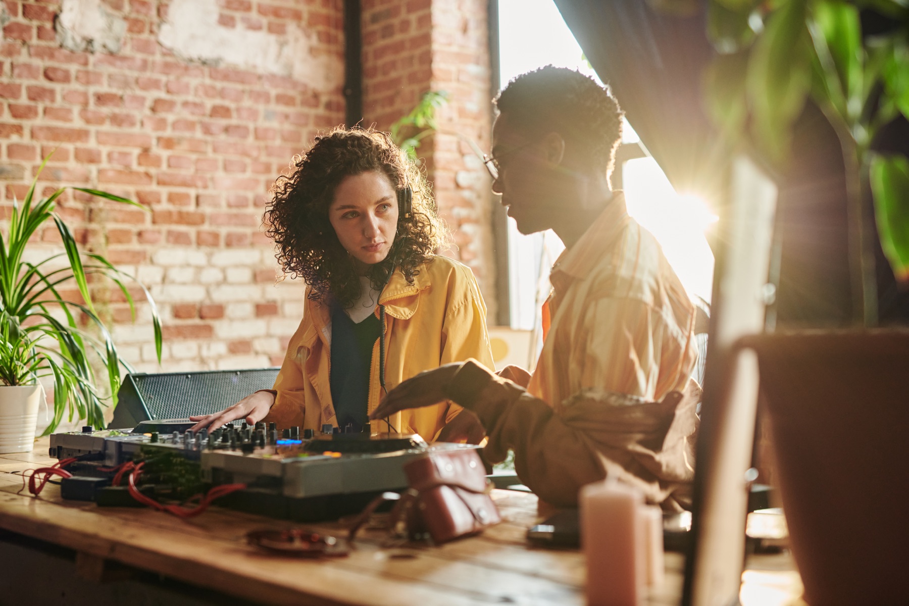Two creators shaping a mix together